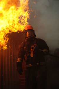 Firefighter in front of building on fire