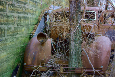 Old rusty wheel against wall