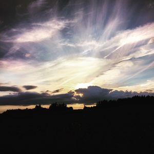 Silhouette landscape against sky during sunset