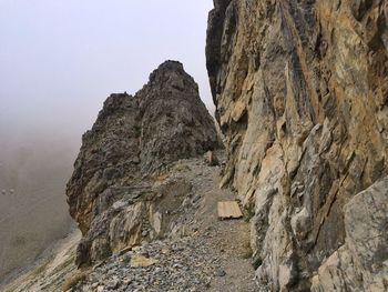 Rock formations on landscape against sky