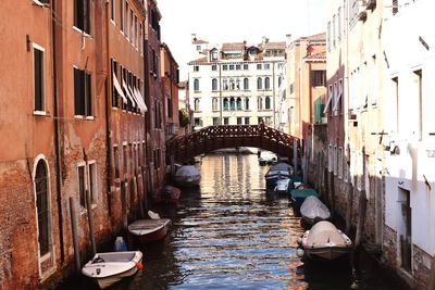 View of boats in canal along buildings