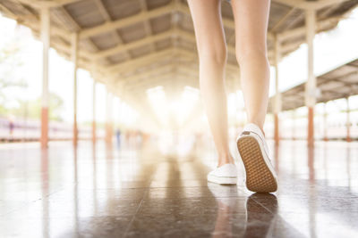 Low section of woman walking on floor