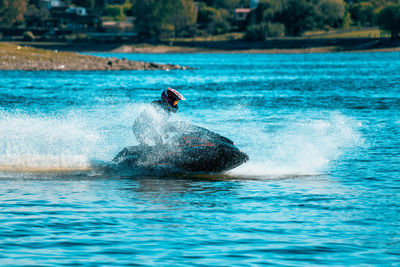 Man driving a jet ski at a lake