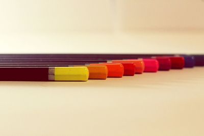 Close-up of multi colored pencils on table