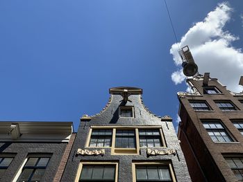 Low angle view of buildings against blue sky