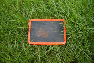 High angle view of information sign on grass