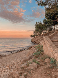 Scenic view of beach against sky during sunset