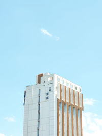 Low angle view of modern building against blue sky