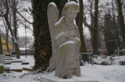 Statue against trees during winter