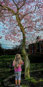 Woman standing on grassy field in park