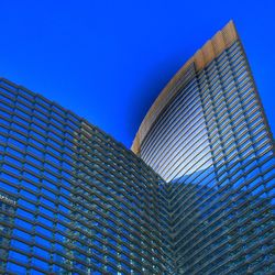 Low angle view of modern building against clear blue sky