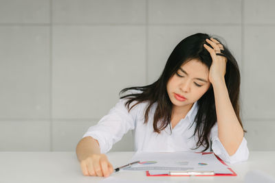 Tired businesswoman sitting at desk in office