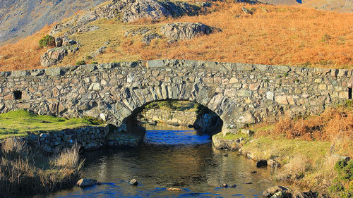 Shadow of man on rock by river