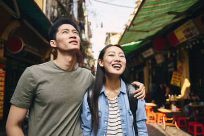 Young couple smiling in city