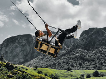 Low angle view of man walking on mountain