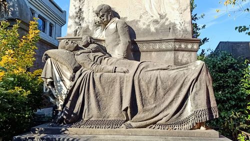 Low angle view of statue against building