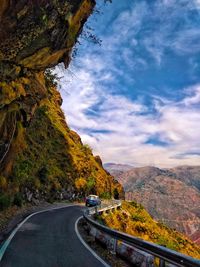 Road amidst trees against sky