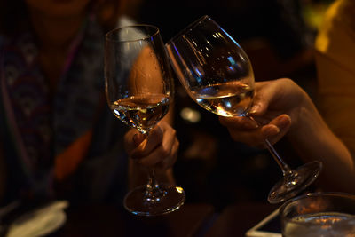 People holding glass of wine