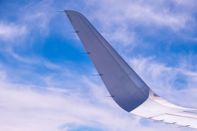 Low angle view of airplane flying against sky