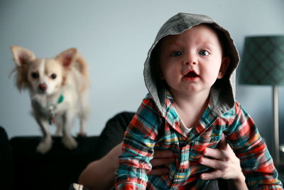 Cropped image of woman holding baby boy at home