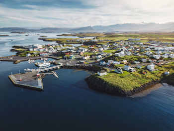 High angle view of townscape by sea against sky