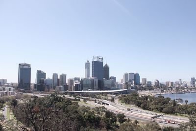 View of city buildings against clear sky
