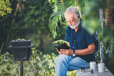 Man sitting on potted plant