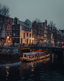 Bridge over river in city at night