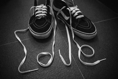 Love text with shoelace on floor