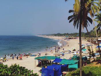 People at beach against sky