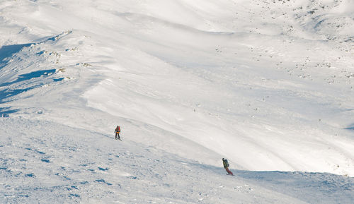 People skiing on snowcapped mountain