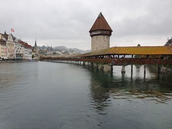 Bridge over river with buildings in background