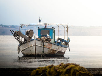 Boat moored in sea against clear sky