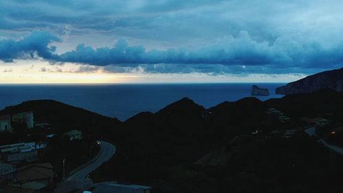 Scenic view of sea and buildings against sky during sunset