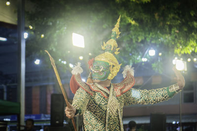 Rear view of woman with arms raised