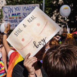 Rear view of people holding text