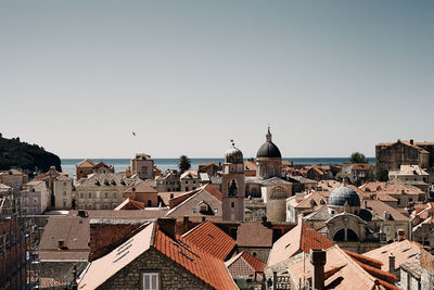 Buildings in city against clear sky