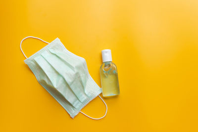 High angle view of bottle on table against yellow background