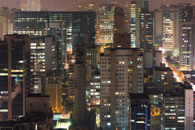 Aerial view of illuminated buildings in city at night