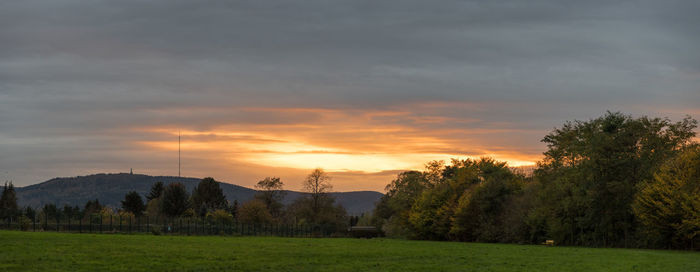 Scenic view of field against sky during sunset