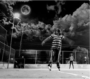 People playing basketball court against sky