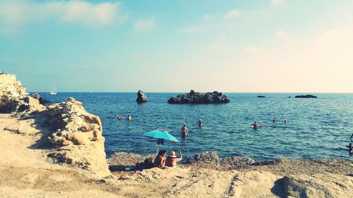 Scenic view of people on beach