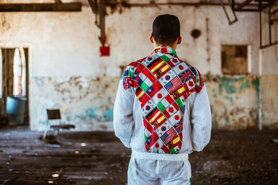 Rear view of man standing against building