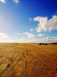 Scenic view of beach against blue sky