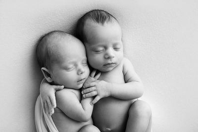 High angle view of babies lying on bed