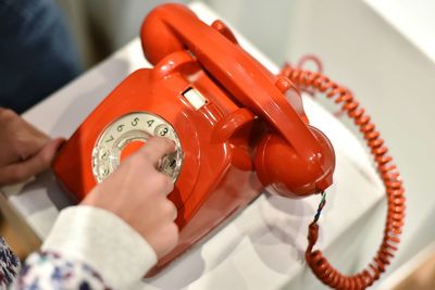 Cropped hand dialling on telephone