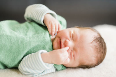 Cute baby boy sleeping on bed