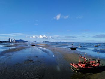 Boats moored on sea against sky