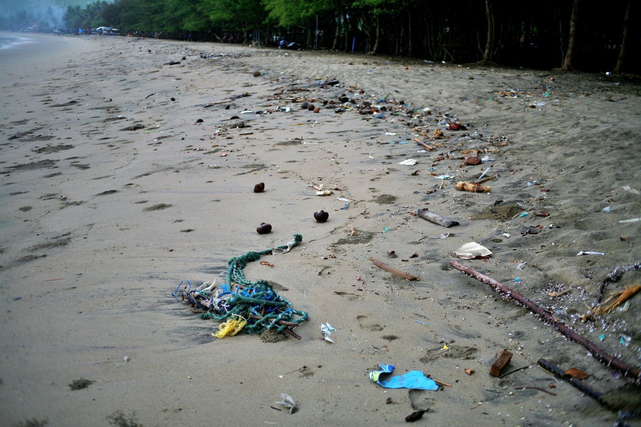 HIGH ANGLE VIEW OF GARBAGE ON SHORE