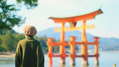 Rear view of man standing against temple